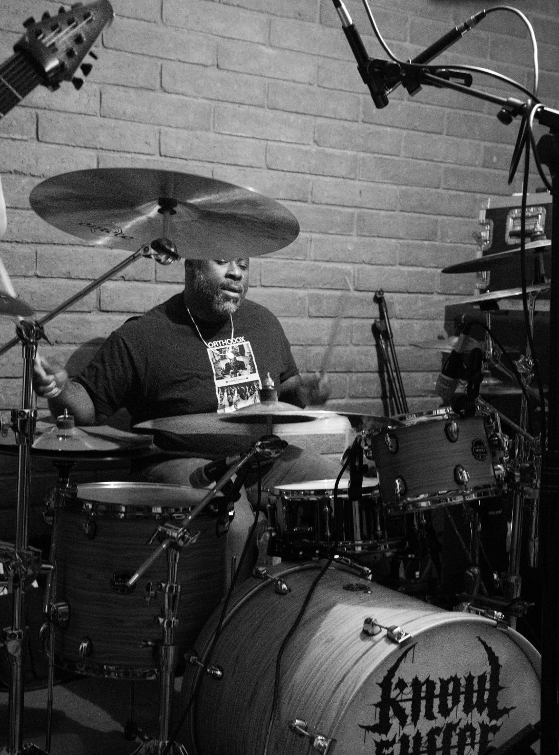 Drummer playing a full kit with overhead mics during a GoatHead Audio recording session