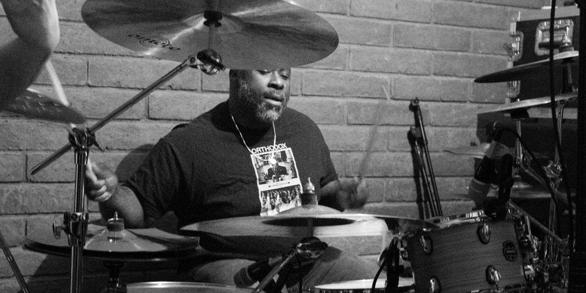 Two musicians, mic stands, sound panels - Albuquerque recording session