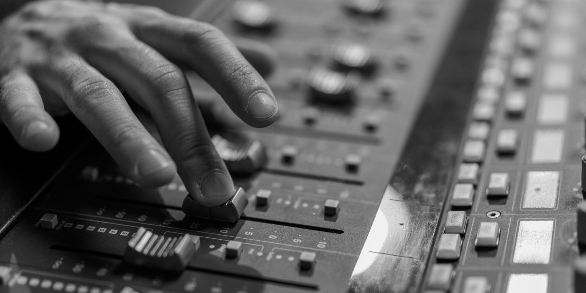 Mastering session metering unit with VU meters glowing in studio